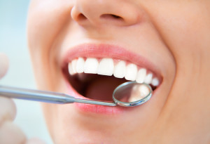 Close-up of young female having her teeth examinated