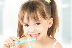 dental hygiene. happy little girl brushing her teeth